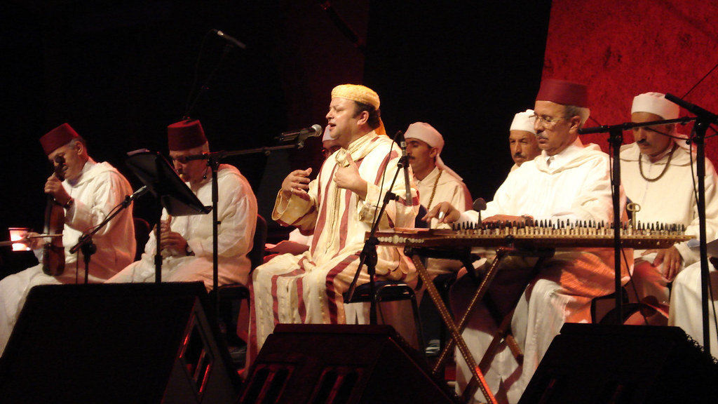 Colorful collage showcasing various Moroccan music festivals, featuring musicians performing traditional instruments, vibrant crowds enjoying the celebrations