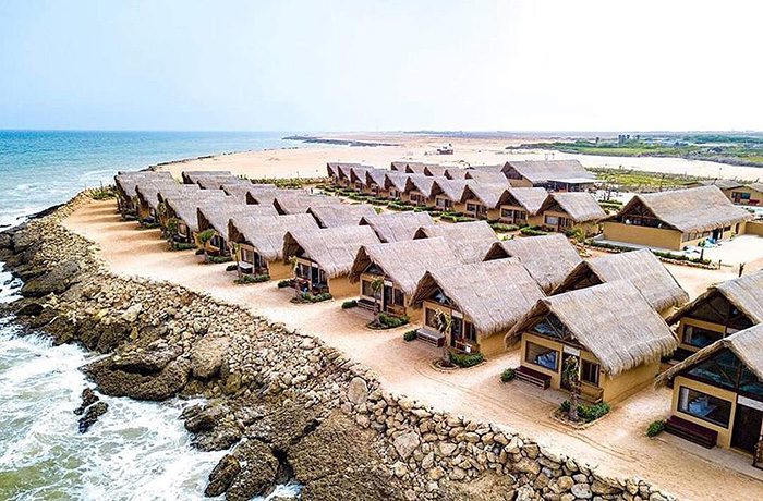 Cozy accommodations in Dakhla City, featuring modern rooms with large windows overlooking the serene lagoon. The image showcases a welcoming atmosphere with comfortable furnishings, vibrant decor, and a view of the stunning natural landscape outside.